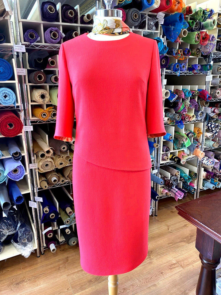 Coral Single Weight Wool Crepe Dress. Bateau Neckline With Asymmetrical Hemline
